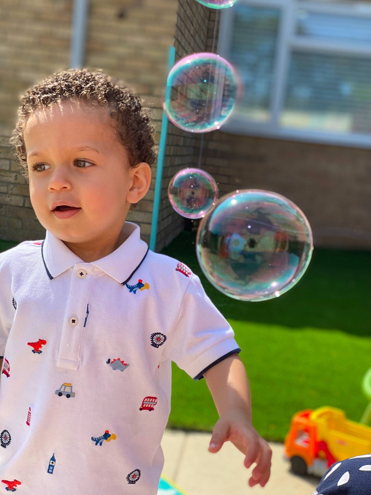 Aydin joined the competition — help win amazing prizes! baby_toddler_clothing, child, electric_blue, eyewear, facial_expression, fun, glass, grass, happy, leisure, liquid_bubble, party_supply, pattern, people_in_nature, person, play, recreation, sleeve, t_shirt, toddler