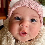 Eyem participe au concours pour gagner de l'argent avec cette photo : baby, close_up, face, hat, pink, knit, pom_poms, fluffy_jacket, cream, curious, wide_eyes, lips, child, cute, winter_wear, warm_clothing, indoor, portrait, infant, soft_texture