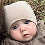 Weston is registered to the contest to win money with this photo: baby, child, face, beanie, hat, camouflage, jacket, outdoor, forest, nature, curious, wide_eyes, person, portrait, headwear, clothing, young, infant, cute, expression