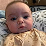 Weston is registered to the contest to win money with this photo: baby, infant, face, eyes, pillow, blanket, onesie, winnie_the_pooh, cartoon, pattern, cute, child, indoors, portrait, closeup, chubby_cheeks, expression, soft_lighting, sleepwear, cozy