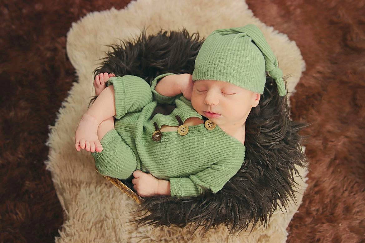 Jaxson is registered to the contest to win money with this photo: baby, baby_toddler_clothing, beanie, cap, child, comfort, fur, grass, happy, headgear, headwear, knit_cap, people_in_nature, person, sitting, textile, toddler, toy, tree, winter