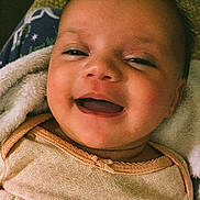 Olivia is registered to the contest to win money with this photo: baby, smiling, infant, face, clothing, blanket, happy, cute, portrait, child, skin, head, eyes, mouth, baby_wipes, fabric, closeup, young, person, indoors