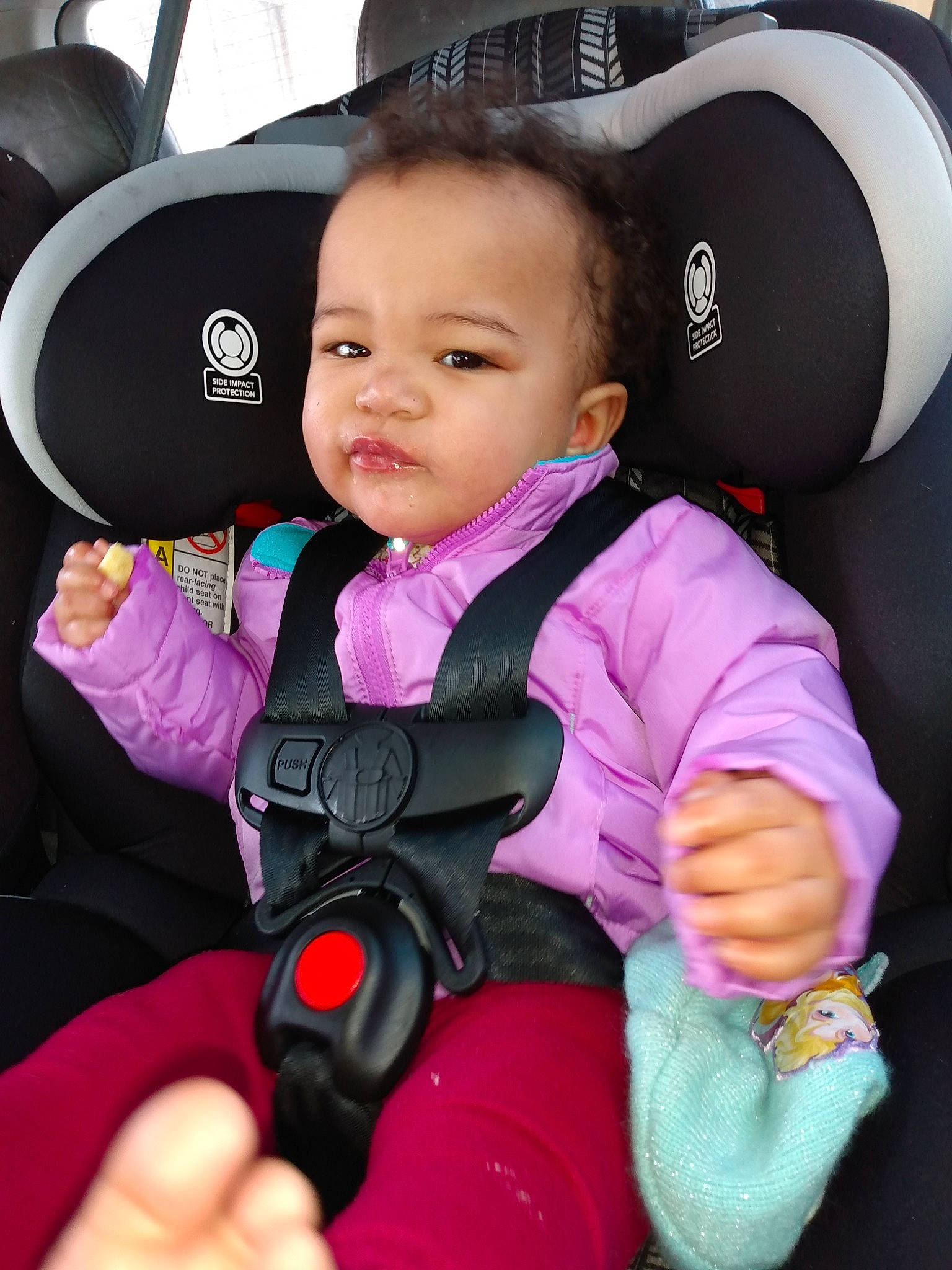 Ava joined the competition — help win amazing prizes! automotive_design, baby, baby_in_car_seat, baby_toddler_clothing, black, car_seat, car_seat_cover, comfort, face, facial_expression, finger, motor_vehicle, outerwear, person, pink, product, purple, steering_part, steering_wheel, toddler