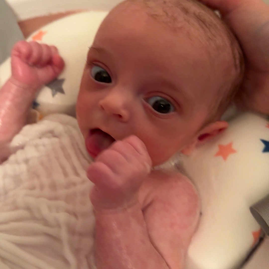 Isabella is registered to the contest to win money with this photo: baby, barefoot, bathing, bathtub, bodypart, crib, face, finger, furniture, hand, head, indoors, infantbed, mouth, newborn, person, photography, portrait, sink, tub