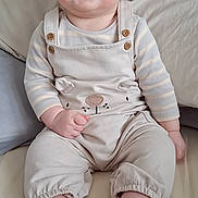 Rory joined the competition — help win amazing prizes! baby, child, smiling, sitting, bed, pillow, blanket, overalls, clothing, cute, happy, infant, tongue, face, head, skin, foot, hand, indoors, person