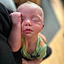 Bentley is registered to the contest to win money with this photo: baby, sleeping, infant, face, hand, cheek, closeup, soft_focus, green_clothing, person, indoors, nap, peaceful, young_child, skin, head, arm, resting, portrait, cute