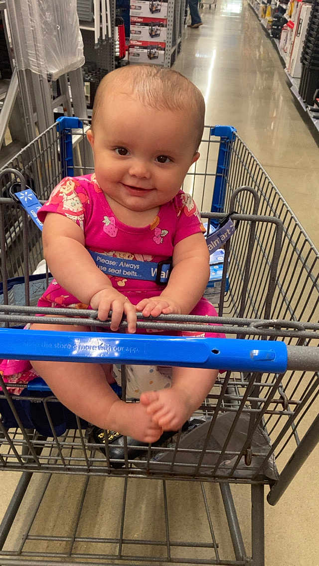 Gracie joined the competition — help win amazing prizes! baby, child, shopping_cart, pink_clothing, smiling, store_aisle, supermarket, floor, metal_cart, footwear, cute, infant, person, happy, retail, seat_belt, plastic, grocery_store, shopping, inside
