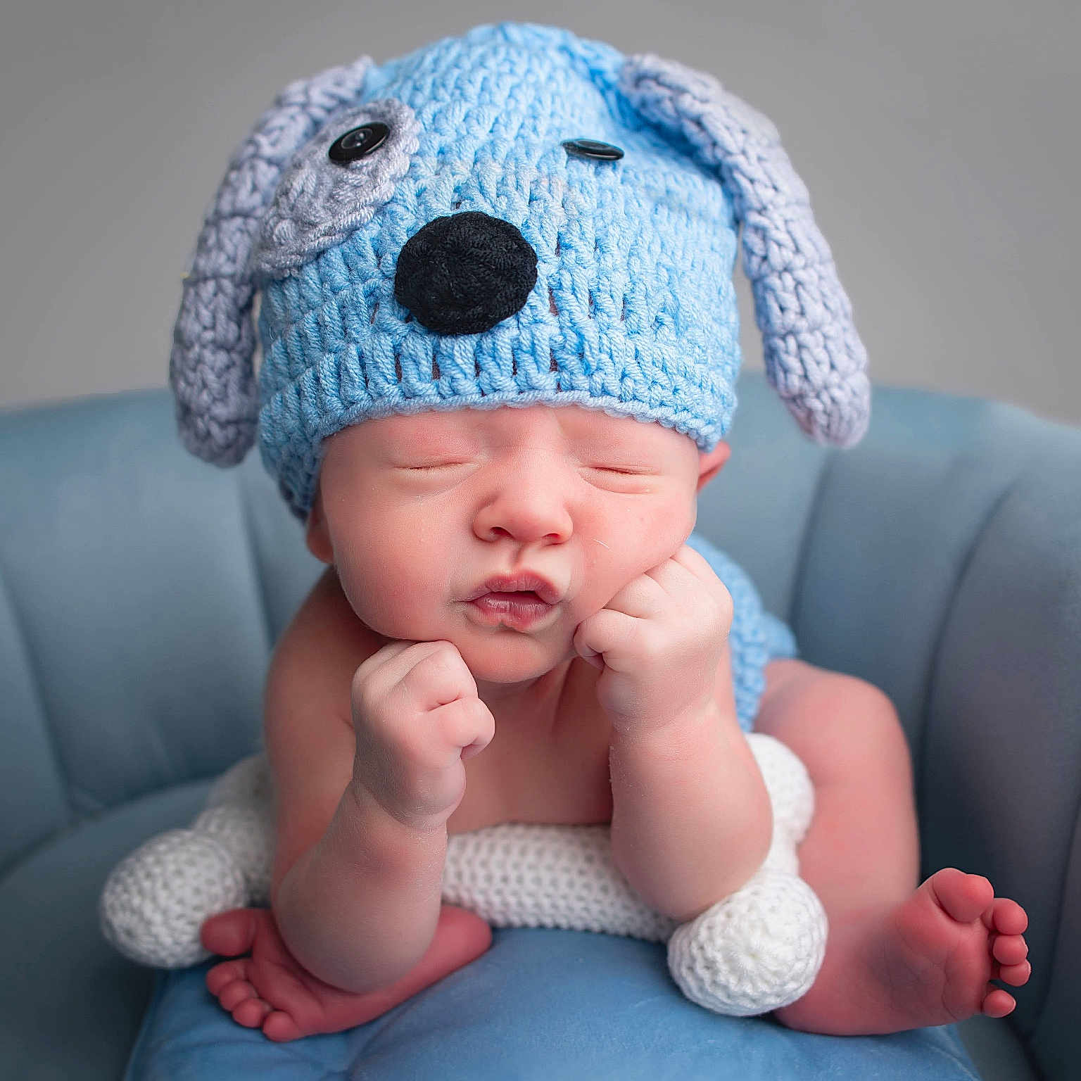 Mason is registered to the contest to win money with this photo: baby, beanie, bodypart, bonnet, cap, clothing, couch, face, finger, furniture, glove, hand, happy, hat, head, newborn, person, photography, portrait, smile