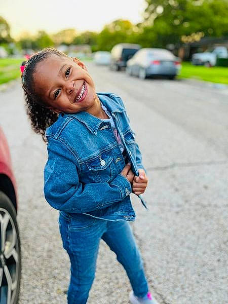 Theodora is registered to the contest to win money with this photo: automotive_tire, car, cool, denim, electric_blue, eye, face, fun, grass, happy, head, jeans, joy, leisure, long_hair, people_in_nature, person, plant, smile, tire