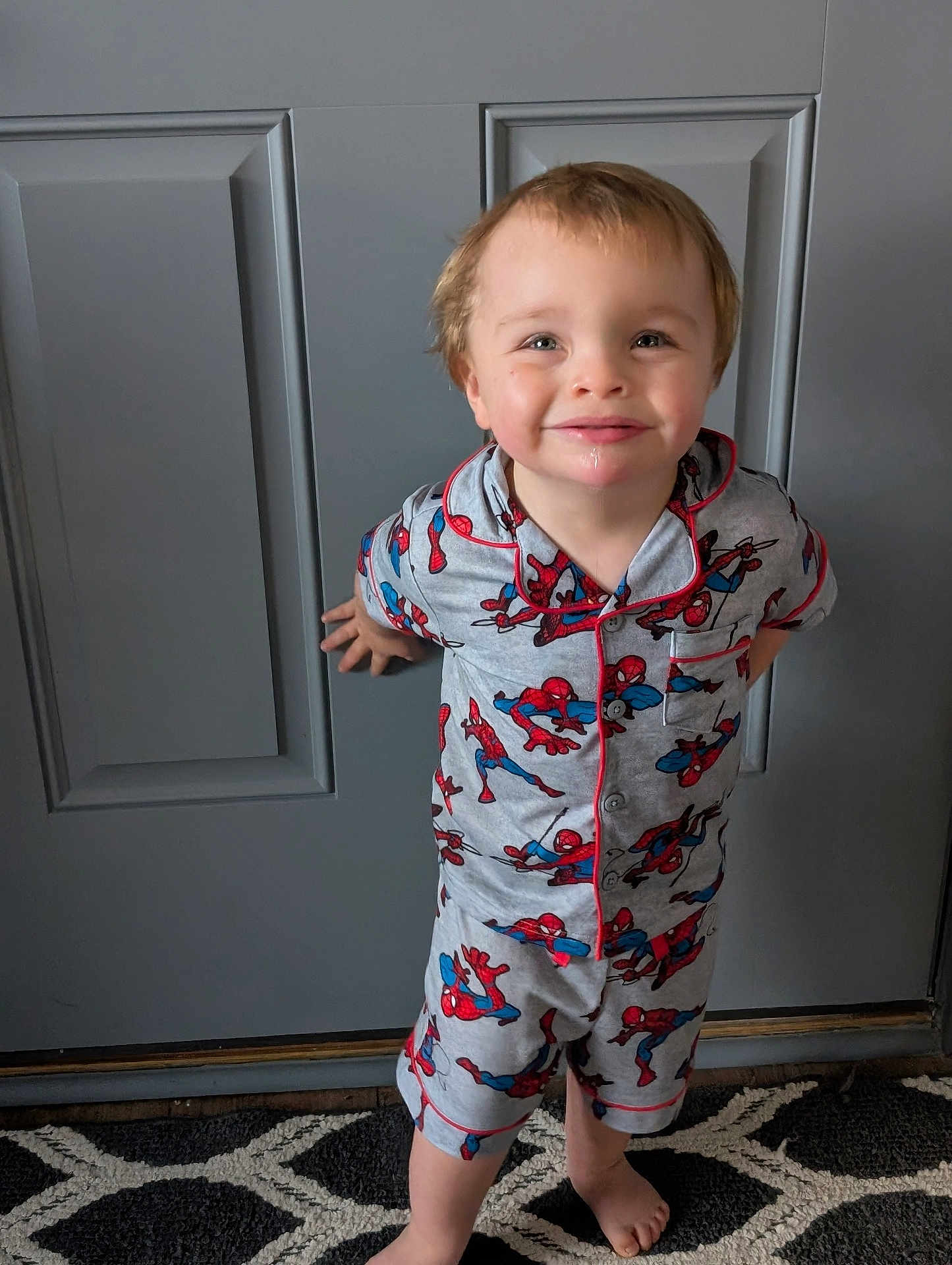 Christian joined the competition — help win amazing prizes! child, toddler, barefoot, pajamas, spiderman, smile, standing, indoors, rug, door, happy, cute, person, clothing, pattern, home, young, face, feet, playful