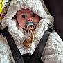 adorable, baby, black_straps, blue_eyes, car_seat, child, close_up, cute, fluffy_jacket, indoors, infant, pacifier, portrait, safety, seatbelt, secure, soft_texture, warm_clothing, white_hood, young_child