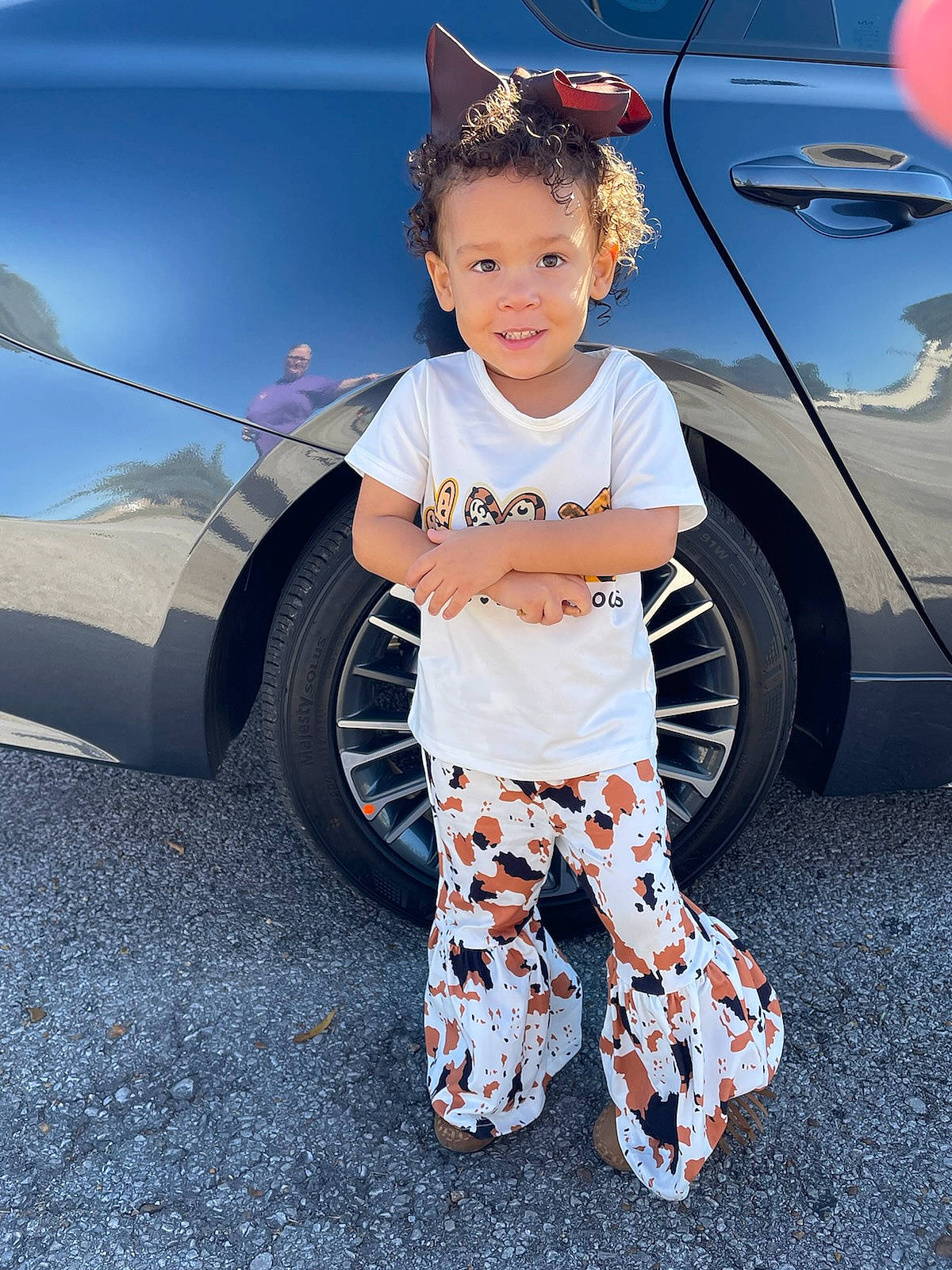 Joanna joined the competition — help win amazing prizes! automotive_design, automotive_exterior, automotive_tire, car, cool, eyewear, fashion, fender, hairstyle, land_vehicle, person, product, rim, sleeve, smile, standing, t_shirt, tire, vehicle, vehicle_door