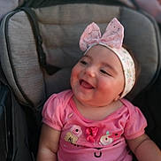 Leylani joined the competition — help win amazing prizes! baby, babylaughing, bonnet, cap, car, car_interior, clothing, face, happy, hat, head, homedecor, newborn, person, photography, portrait, smile, t_shirt, transportation, vehicle