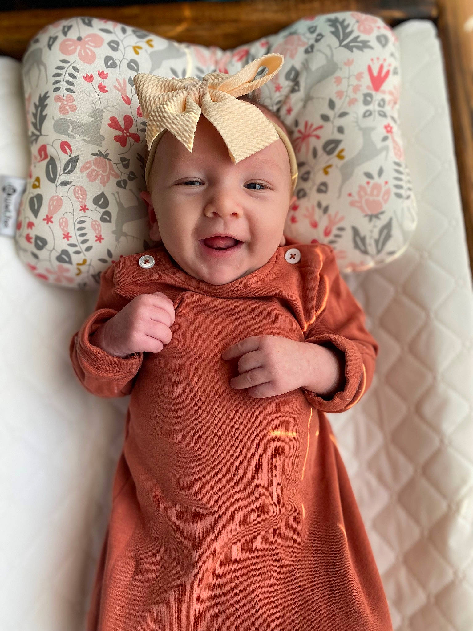 Willow joined the competition — help win amazing prizes! baby, baby_toddler_clothing, cap, child, dress, fashion_accessory, finger, gesture, happy, headgear, headpiece, headwear, jewellery, magenta, outerwear, pattern, peach, person, pink, sleeve