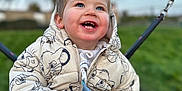 Leo joined the competition — help win amazing prizes! child, toddler, smiling, jacket, hooded_clothing, outdoor, swing, playground, happy, blue_sky, tree, grass, winter_clothing, cute, face, person, young_child, daylight, holding, fun