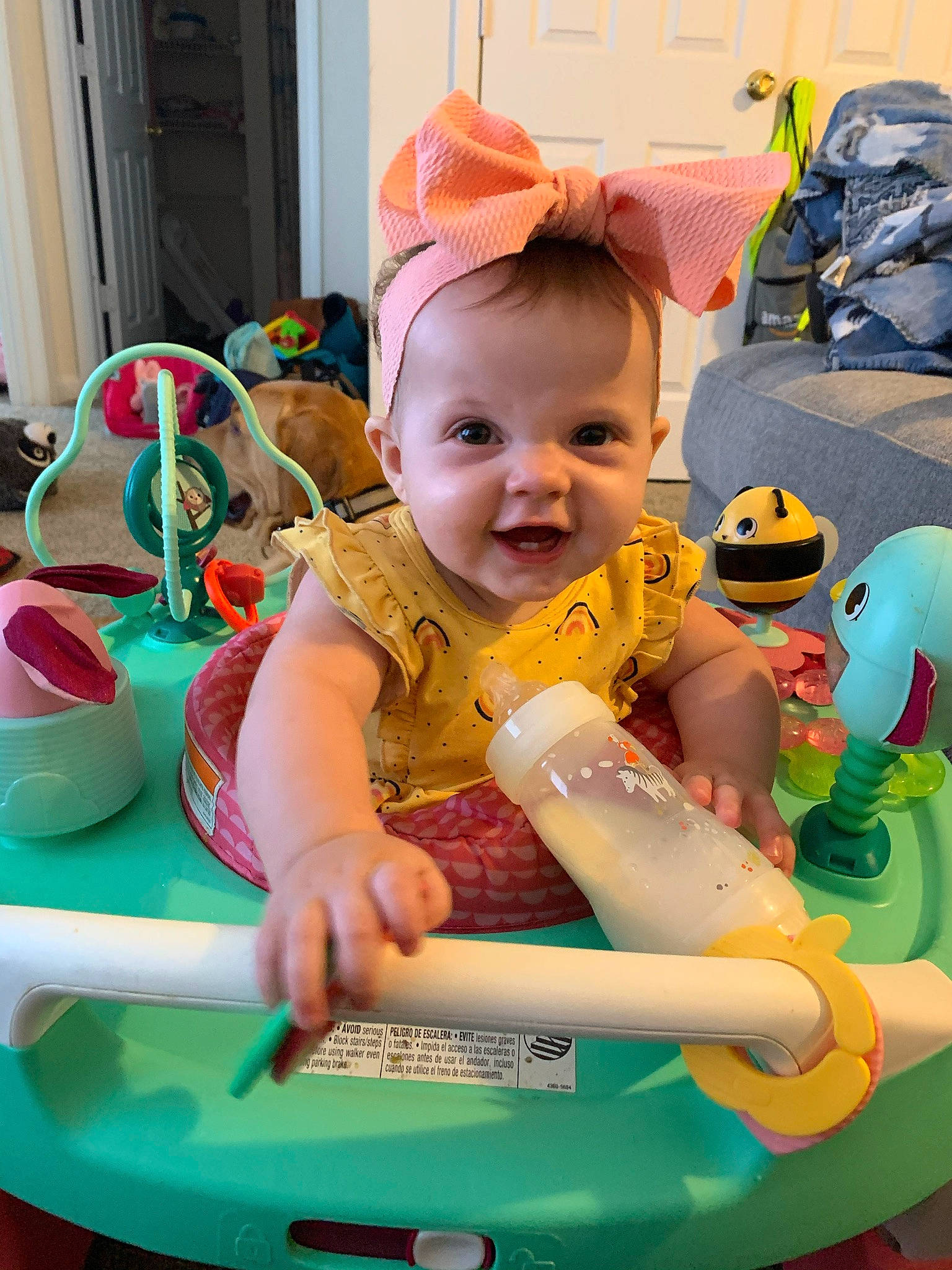 River is registered to the contest to win money with this photo: baby, baby_playing_with_toys, baby_products, baby_toddler_clothing, child, event, facial_expression, fun, green, happy, leisure, person, pink, product, recreation, riding_toy, smile, tire, toddler, toy