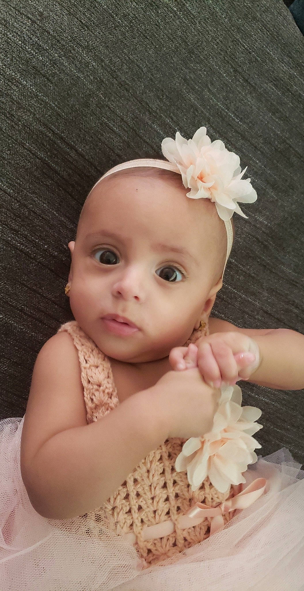 Maria is registered to the contest to win money with this photo: baby, baby_toddler_clothing, beauty, cheek, embellishment, eye, eyelash, finger, flash_photography, flower, happy, headband, headgear, headpiece, iris, lip, person, petal, pink, skin