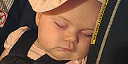 Willow joined the competition — help win amazing prizes! baby, sleeping, car_seat, headband, flower, pink, child, infant, straps, peaceful, face, closeup, soft_lighting, cute, adorable, child_seat, resting, young, portrait, indoors