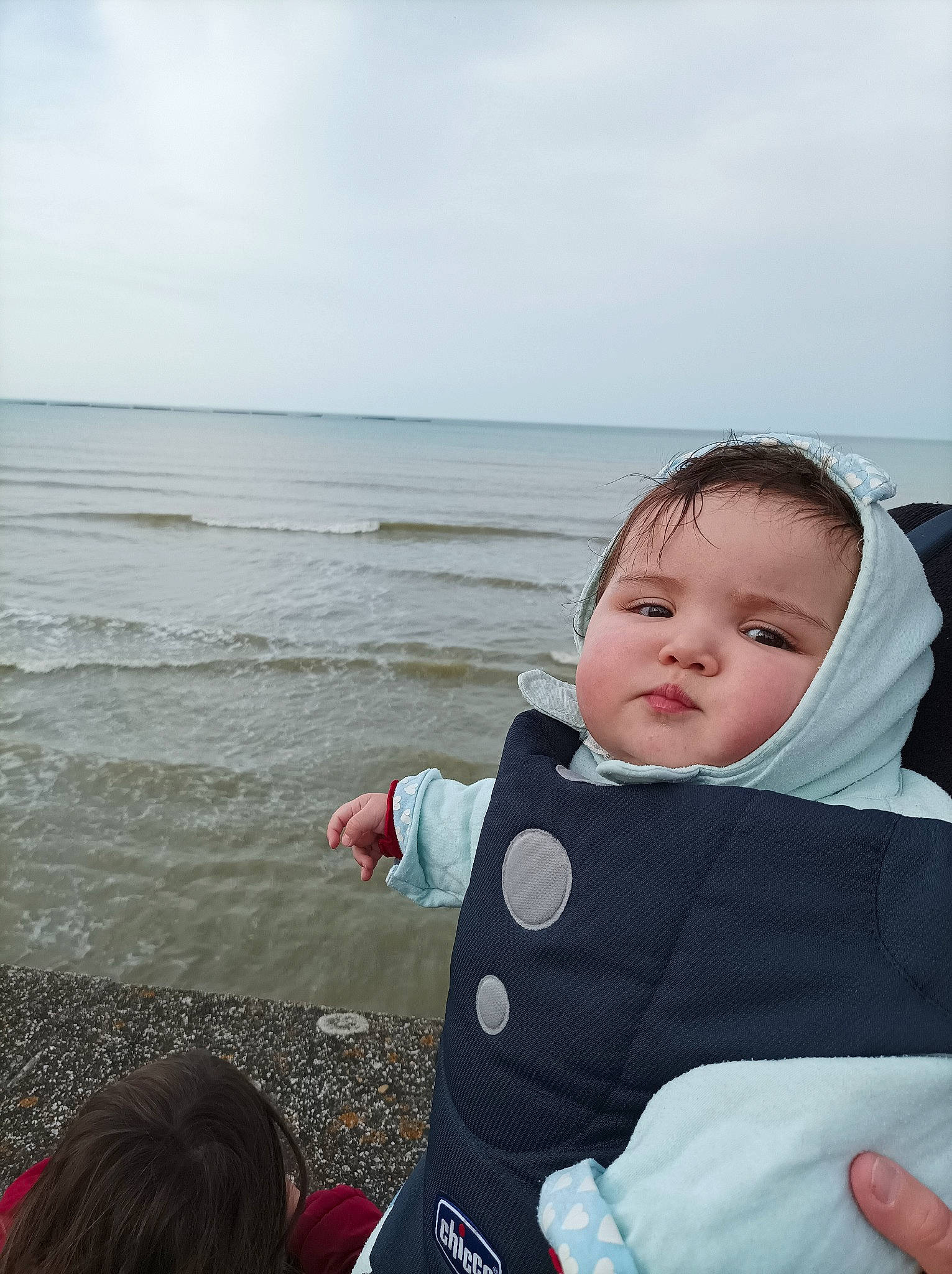 Shayna participe au concours pour gagner de l'argent avec cette photo : baby, baby_products, baby_toddler_clothing, child, cloud, coast, comfort, fun, happy, horizon, leisure, ocean, person, personal_protective_equipment, recreation, sitting, sky, toddler, travel, water