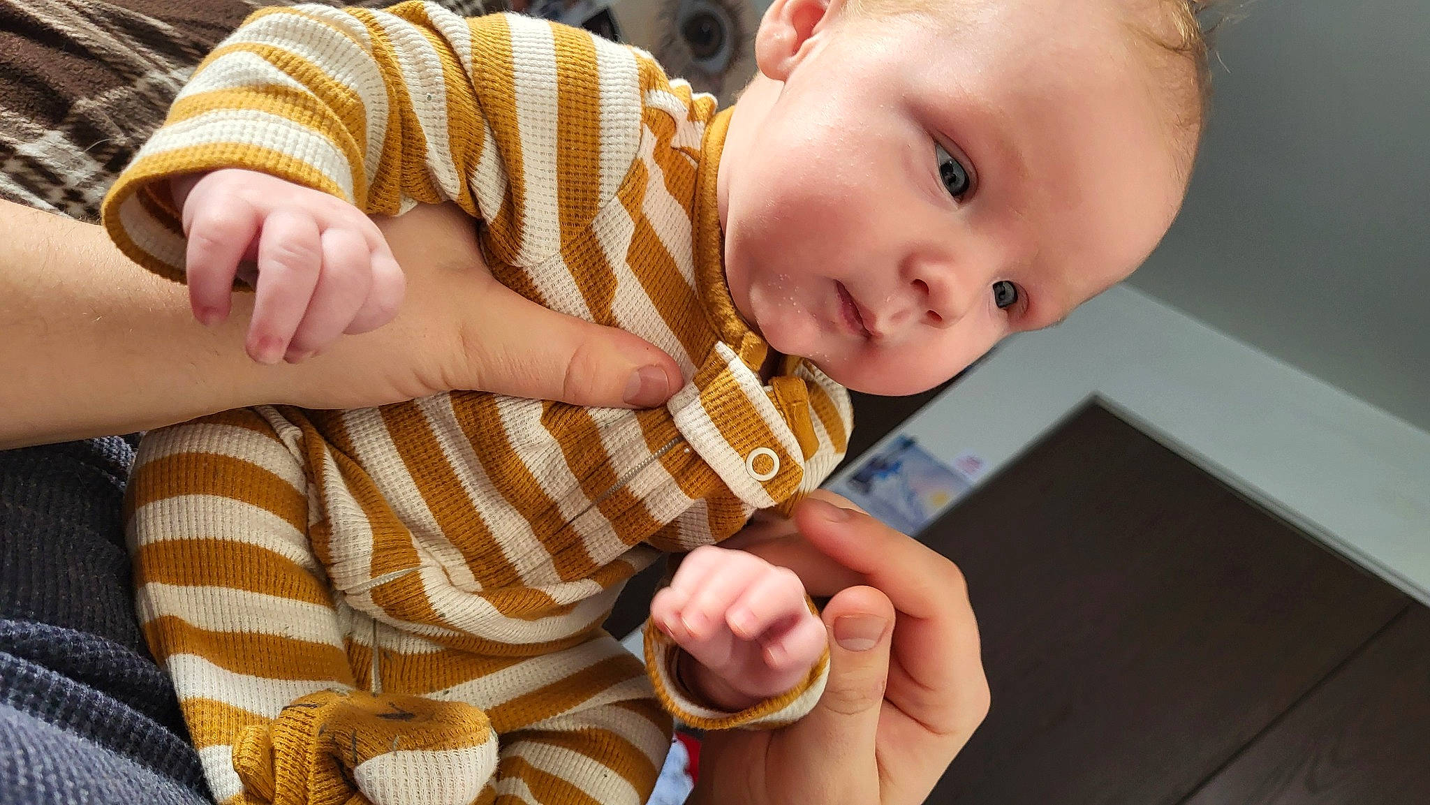 Noah is registered to the contest to win money with this photo: baby, baby_toddler_clothing, cheek, child, comfort, finger, gesture, hand, happy, head, nail, pattern, person, skin, sleeve, smile, tablet_computer, thumb, toddler, wood