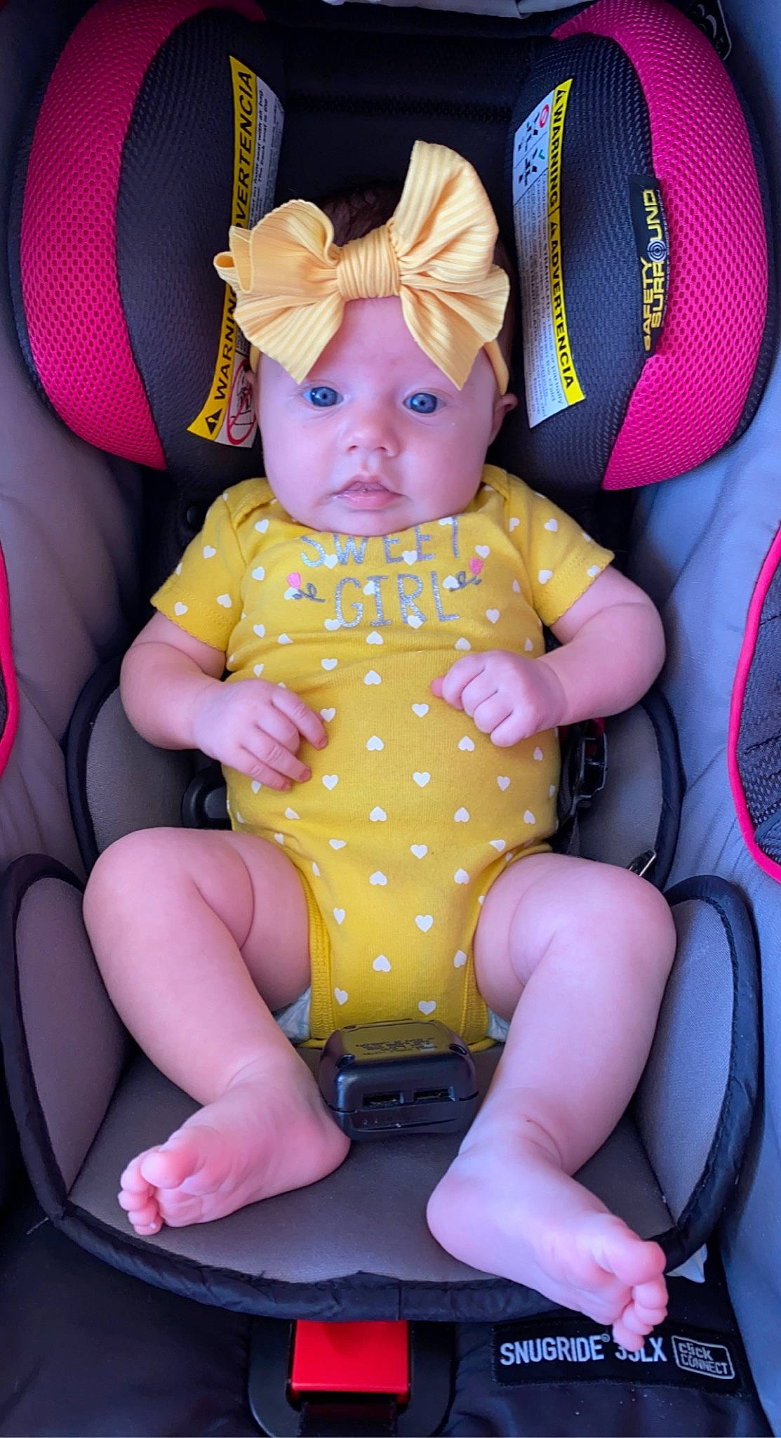Blaire joined the competition — help win amazing prizes! baby, baby_products, baby_toddler_clothing, cap, car_seat, child, comfort, fun, headwear, human_leg, knee, lap, leg, magenta, pattern, person, pink, purple, sitting, thigh