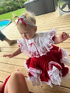 Kingsley is registered to the contest to win money with this photo: baby, baby_toddler_clothing, child, costume, event, flooring, fun, goggles, grass, happy, hardwood, leisure, magenta, person, pink, plant, sitting, sock, thigh, toddler