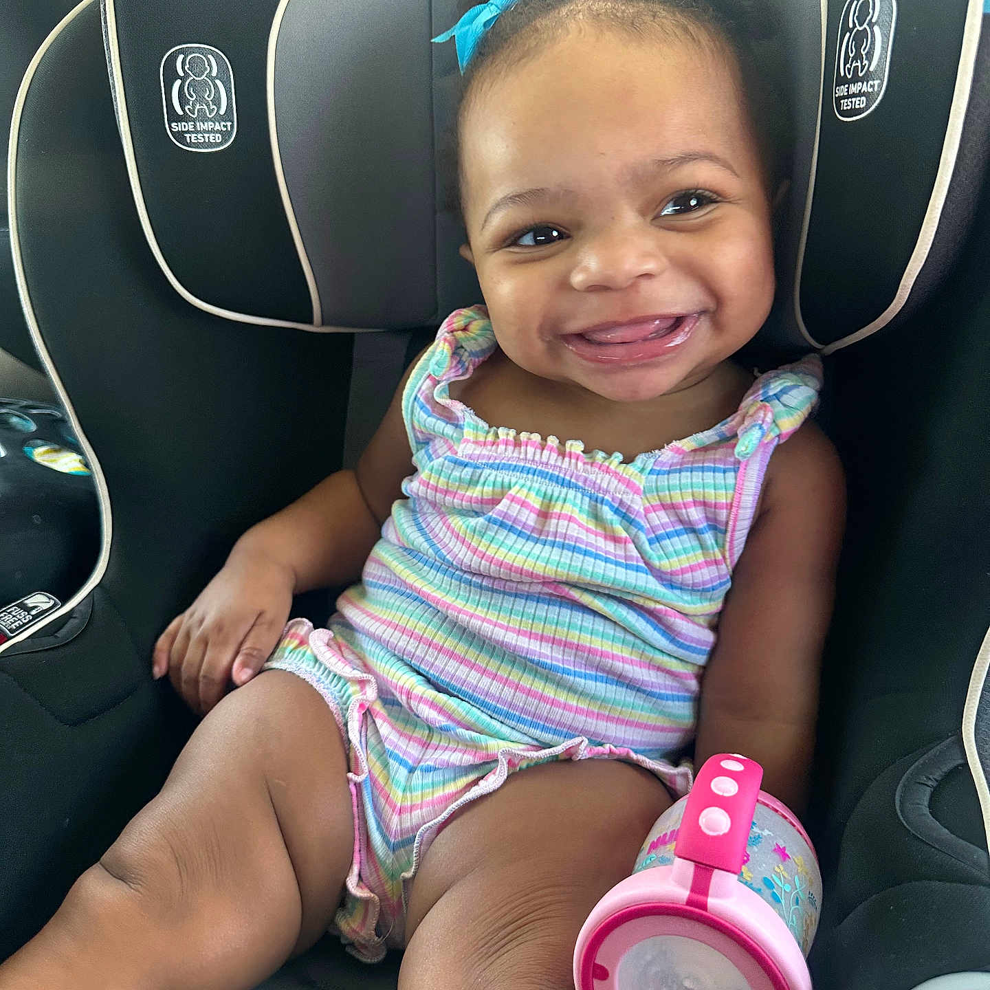 Jasmine joined the competition — help win amazing prizes! accessories, baby, babylaughing, car, clothing, cushion, diaper, dress, face, happy, head, homedecor, person, photography, portrait, sitting, smile, tape, transportation, vehicle