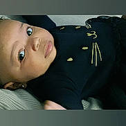 Jasmine is registered to the contest to win money with this photo: baby, black_clothing, blanket, child, close_up, couch, cute, earring, embroidered_design, eyes, face, home_interior, infant, lips, long_eyelashes, lying_down, portrait, skin, soft_lighting, whisker_motif