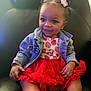toddler, child, smiling, denim_jacket, red_tutu, strawberry_shirt, mickey_mouse, pigtails, hair_accessories, black_chair, comfortable, happy, cute, indoor, portrait, fashion, sparkling_eyes, seated, young_child, playful