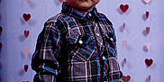 Samuel joined the competition — help win amazing prizes! blond_hair, boy, button_up, carpet_floor, casual_clothing, child, cute, expressionless, hands, hanging_hearts, indoor, jeans, plaid_shirt, portrait, rosy_cheeks, small_person, standing, studio_backdrop, toddler, valentine_theme
