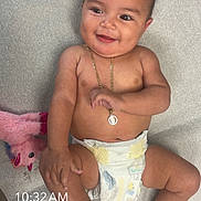 Auhora joined the competition — help win amazing prizes! baby, smiling, diaper, necklace, toy, pink, soft_surface, child, infant, cute, happy, skin, lying_down, adorable, playful, indoor, person, young_child, toddler, portrait