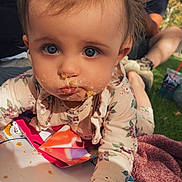 Opal joined the competition — help win amazing prizes! baby, child, face, blue_eyes, crumbs, paper_plates, blanket, outdoor, grass, people, adult, sitting, casual_clothing, daylight, picnic, hand, expression, closeup, nature, family