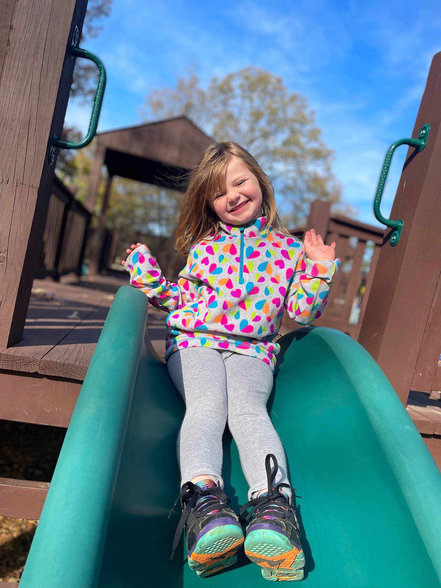 Elizabeth is registered to the contest to win money with this photo: aqua, beauty, chute, city, electric_blue, fun, hair, happy, joy, leisure, outdoor_play_equipment, person, pink, playground, public_space, recreation, sky, smile, snapshot, standing