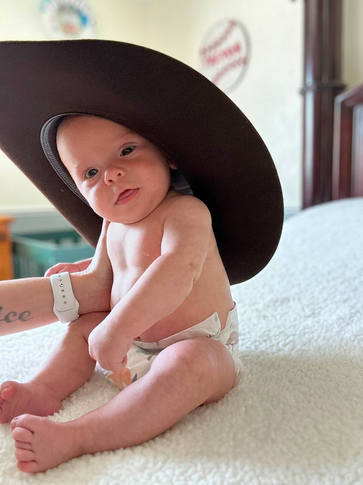 Trevor is registered to the contest to win money with this photo: baby, barefoot, cap, fashion_accessory, fedora, flash_photography, flooring, foot, fun, happy, hat, headwear, human_leg, knee, lip, person, sitting, skin, sun_hat, thigh