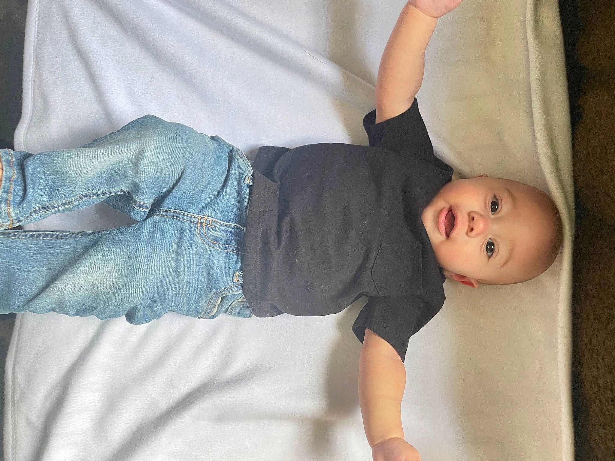 Aiden is registered to the contest to win money with this photo: arm, baby, baby_toddler_clothing, comfort, elbow, finger, gesture, hand, human_body, joint, knee, leg, person, product, shoulder, skin, sleeve, stomach, textile, thigh