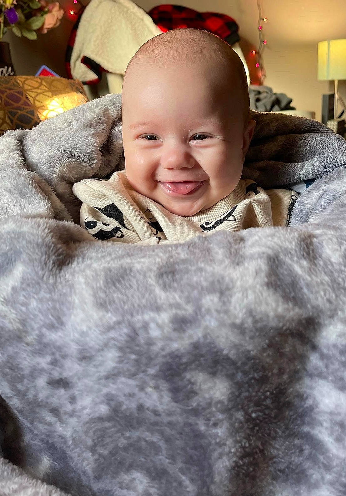 Aiden is registered to the contest to win money with this photo: baby, child, christmas, comfort, event, flash_photography, flooring, fun, fur, fur_clothing, happy, iris, joy, laugh, linens, person, portrait_photography, sitting, skin, smile