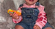 Delilah Rain joined the competition — help win amazing prizes! baby, blanket, bow, child, clothing, cozy, cute, denim_overalls, face, happy, indoors, infant, pink_headband, playful, portrait, sitting, smiling, sock, soft_texture, toy_car
