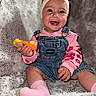 baby, child, smiling, pink_headband, bow, denim_overalls, toy_car, sitting, blanket, happy, cute, indoors, cozy, soft_texture, sock, portrait, infant, clothing, face, playful
