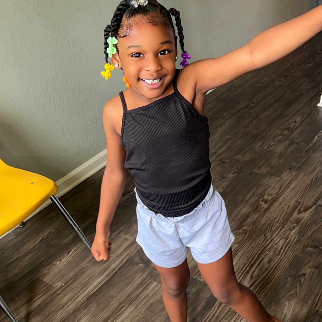 Mahaylei Carter is registered to the contest to win money with this photo: accessories, child, clothing, dress, face, female, furniture, girl, happy, hardwood, head, jewelry, necklace, person, photography, portrait, shorts, skirt, smile, wood
