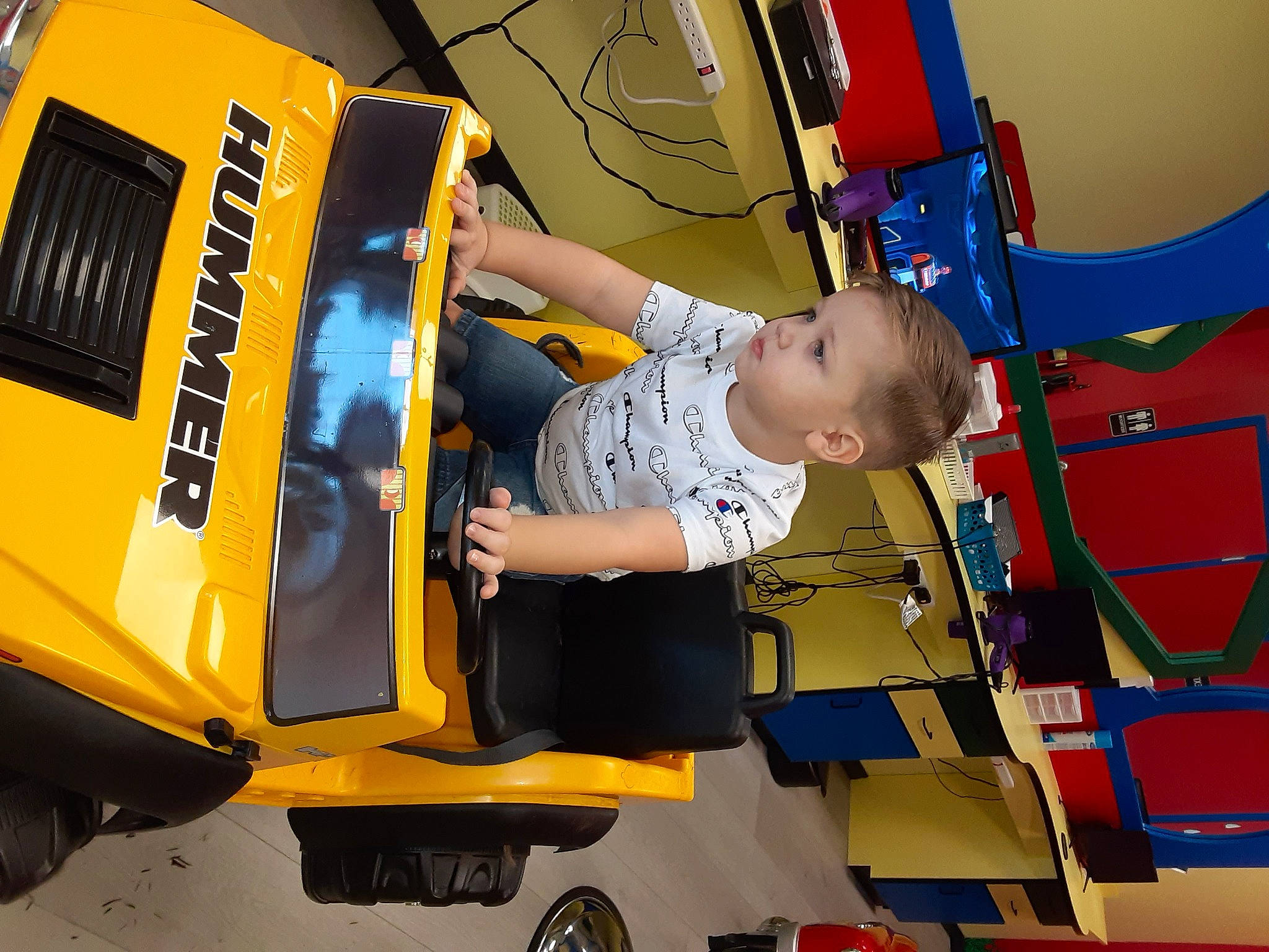 Kace is registered to the contest to win money with this photo: auto_part, automotive_design, automotive_exterior, automotive_lighting, automotive_tire, automotive_wheel_system, bumper, electric_blue, engineering, fun, hood, machine, motor_vehicle, person, recreation, t_shirt, tire, toddler, vehicle_door, wheel