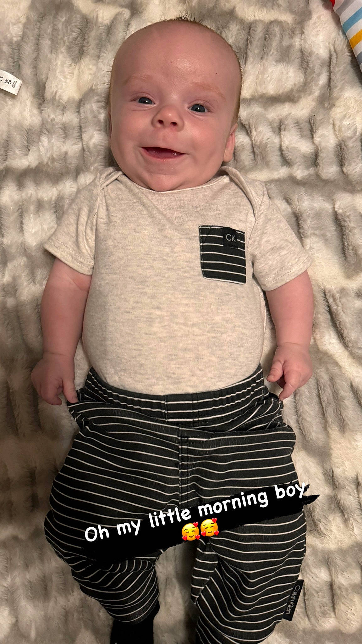 Chance is registered to the contest to win money with this photo: baby_toddler_clothing, black, cheek, eye, face, grey, head, human_body, joint, neck, organ, outerwear, person, product, shoulder, skin, sleeve, smile, standing, textile