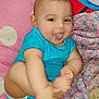 Isaiah joined the competition — help win amazing prizes! baby, child, blue_clothing, smiling, tongue_out, blanket, cushion, indoor, cute, playful, infant, happy, person, skin, head, hand, foot, tattoo, fabric, colorful