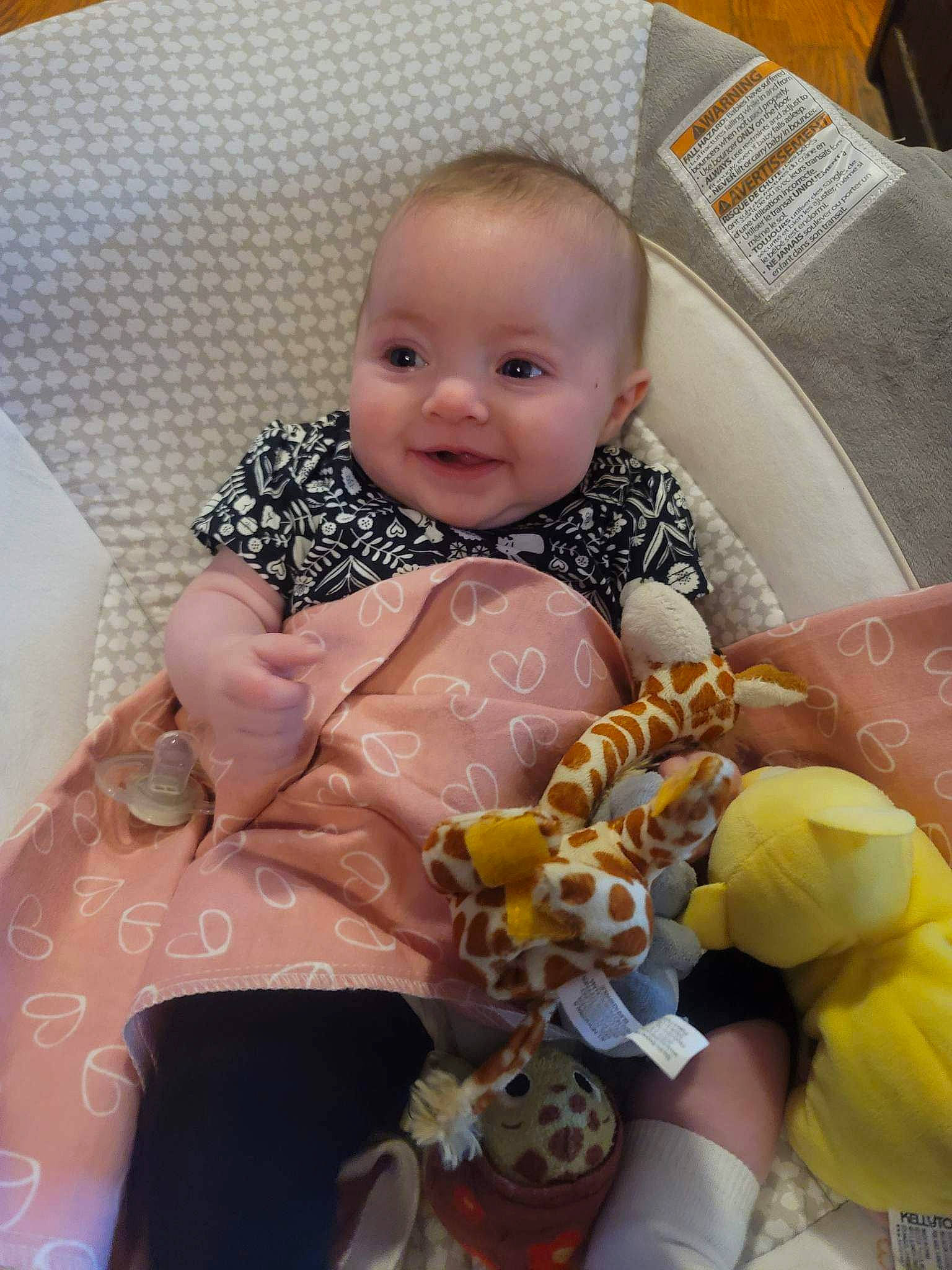 Hannah is registered to the contest to win money with this photo: baby, baby_products, baby_toddler_clothing, chair, cheek, child, comfort, event, happy, head, iris, joy, linens, person, pink, room, sitting, skin, smile, textile