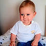 baby, child, curious_expression, cushion, cute, denim_shorts, green_leaves, hands, indoor, plant, portrait, seated, short_hair, skin, socks, stars_pattern, toddler, wall, white_shirt, young_child