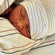 Gabriel joined the competition — help win amazing prizes! newborn, baby, sleeping, blanket, striped_cap, hospital, closeup, face, infant, soft_texture, wrapped, peaceful, cozy, skin, person, headwear, resting, bed, cute, toddler