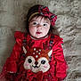 adorable, baby, bow_headband, child, clothing, cute, expression, face, festive, holiday, indoors, infant, lying_down, plaid, portrait, red_dress, reindeer, smiling, soft_blanket, young_child