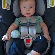 Kobin joined the competition — help win amazing prizes! baby, bottle, car_seat, child, clothing, face, green_shirt, harness, indoors, infant, pants, photography, portrait, safety, seat_belt, sitting, sock, vehicle, warning_label, wide_eyed