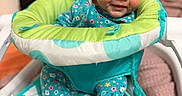 Maela is registered to the contest to win money with this photo: activity_seat, baby, baby_walker, bedroom, cartoon_eyes, child, colorful, cozy, cushion, face, floral_outfit, happy, indoors, infant, photography, playful, portrait, seated, smiling, toy