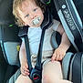 Leo participe au concours pour gagner de l'argent avec cette photo : toddler, child, car_seat, pacifier, curly_hair, blue_eyes, sitting, car_interior, safety_harness, clothing, shorts, white_shirt, seatbelt, baby, infant, young_child, person, skin, hand, leg