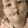 Leo participe au concours pour gagner de l'argent avec cette photo : child, face, portrait, close_up, expression, funny_face, puckered_lips, sepia, tshirt, casual_clothing, cute, innocence, young, person, childhood, playful, eyes, hair, indoor, smile